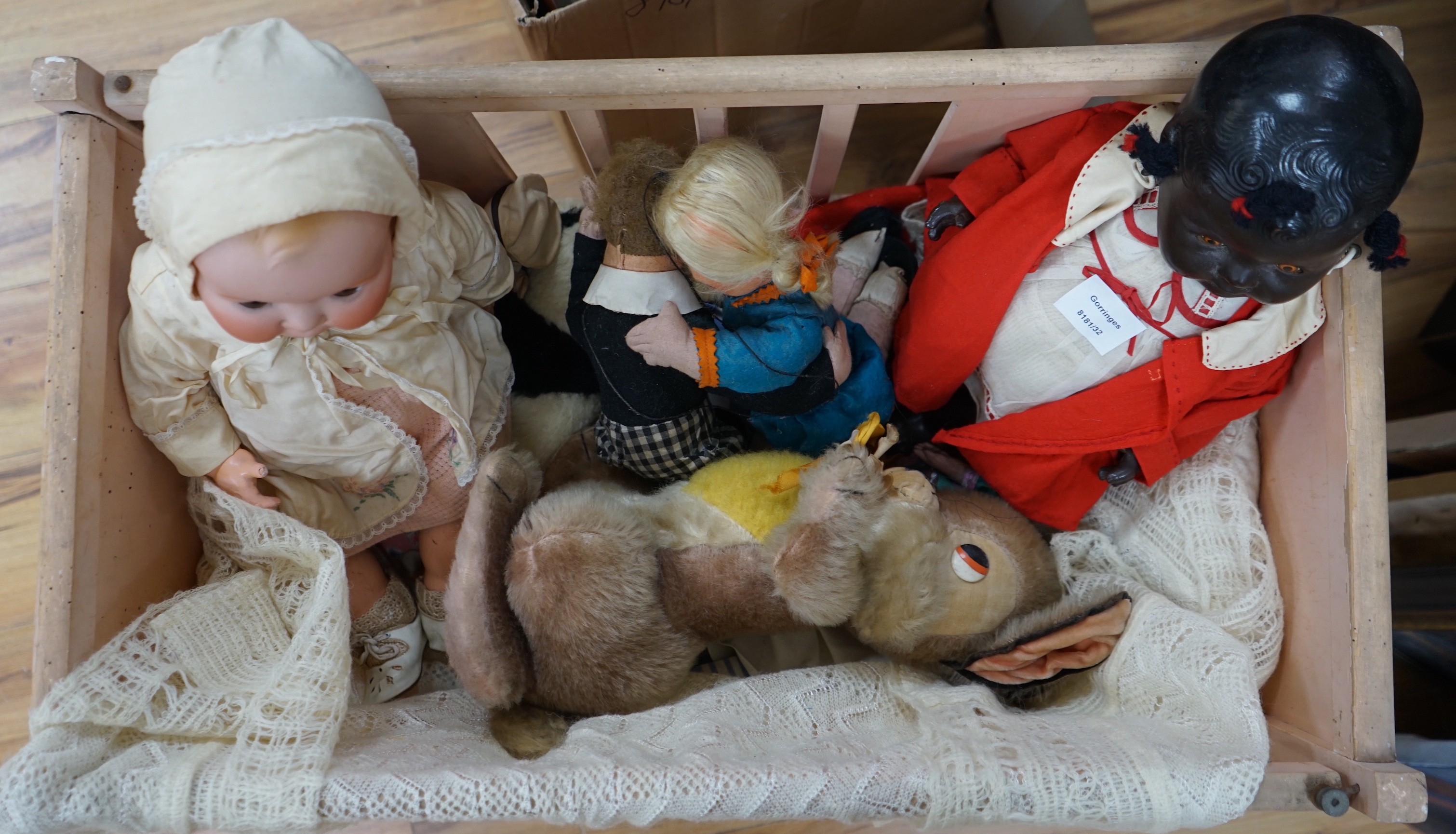 An Armand Marseille bisque head baby doll, a black plastic doll and other dolls and toys